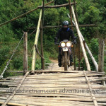 Vietnam dirt bike tours over a bamboo bridge