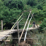 Vietnam dirt bike tours over a bamboo bridge