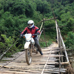 Vietnam dirt bike tours over a bamboo bridge