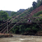 Vietnam dirt bike tours over a bamboo bridge