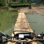 Vietnam dirt bike tours over a bamboo bridge