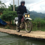 Vietnam dirt bike tours over a bamboo bridge